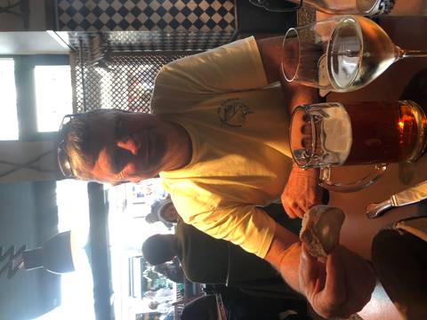 Man enjoying a beer at a restaurant.