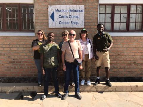 Group of people outside a coffee shop building.