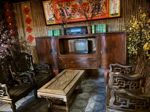       Interior of a traditional room with wooden furniture and old electronics.
  