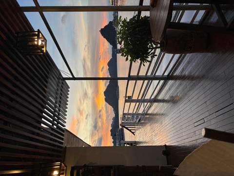View from a boat deck at sunset with scenic limestone formations in the bay.