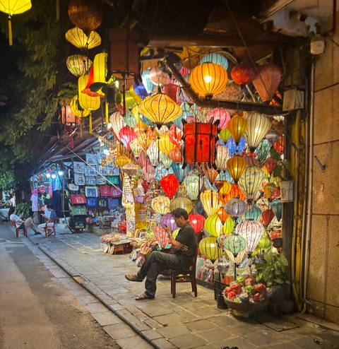 Street vendor with an array of brightly colored lanterns and decorations.