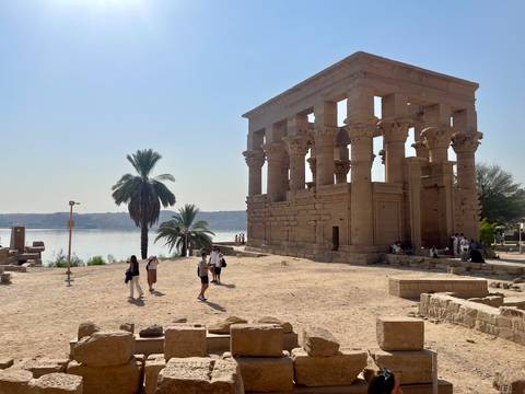 People exploring historical riverside ruins.