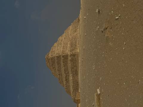 Step Pyramid in the desert under a clear sky.