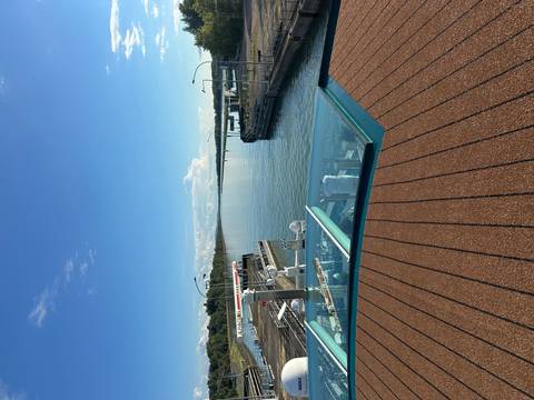 View from a cruise ship deck overlooking a waterway.