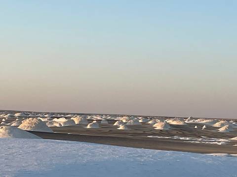       White sand formations in the desert at dusk.
  