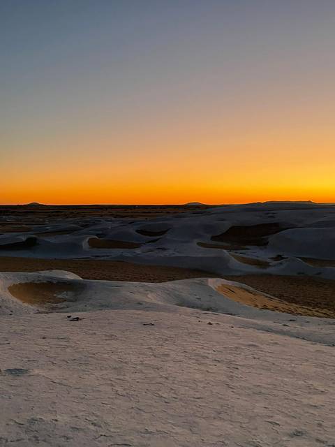       Twilight sky over sand dunes.
  
