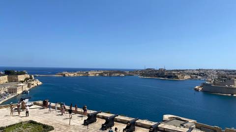 Coastal view with a large bay and people viewing.