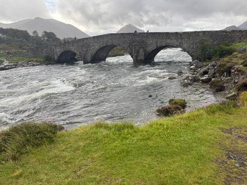 An old stone bridge over a river.
