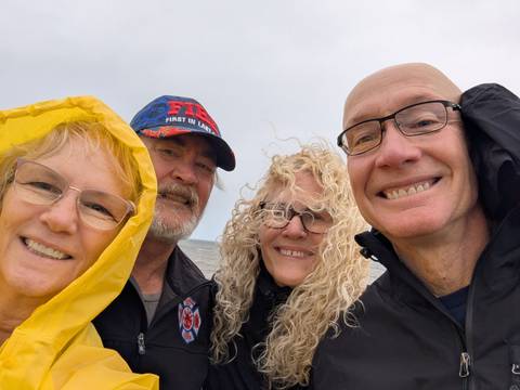 Group selfie at a windy beach