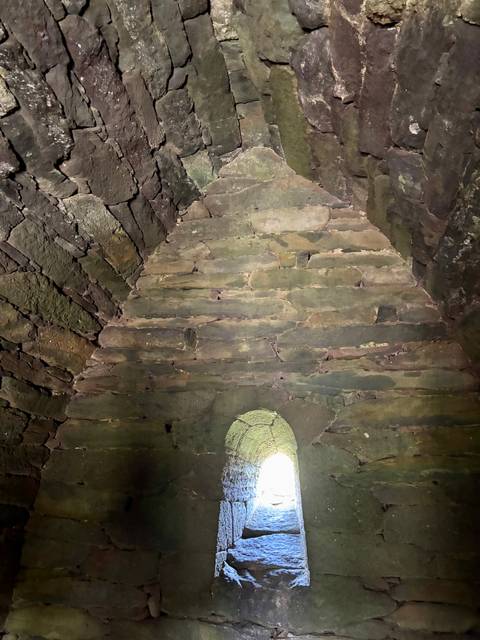 Stone archway interior with round opening at the top.