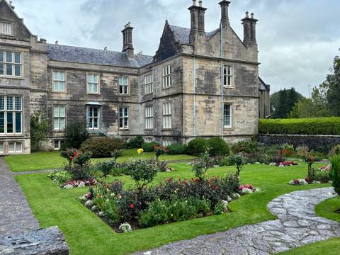Historic building with well-maintained garden.