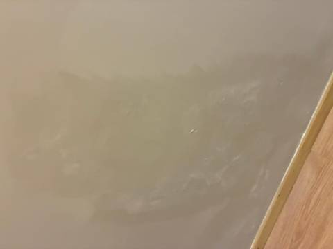 Wall with unclear texture and fading paint.