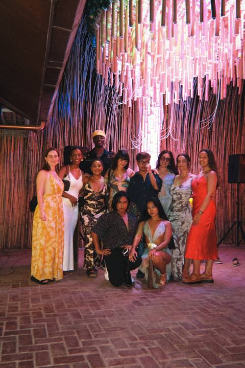 Group of people dressed stylishly, posing together indoors.