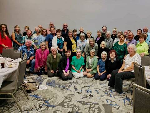 A large group of people posing indoors.