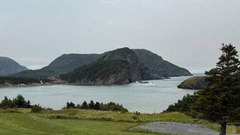 Rocky coastline with a distant view of a red structure.