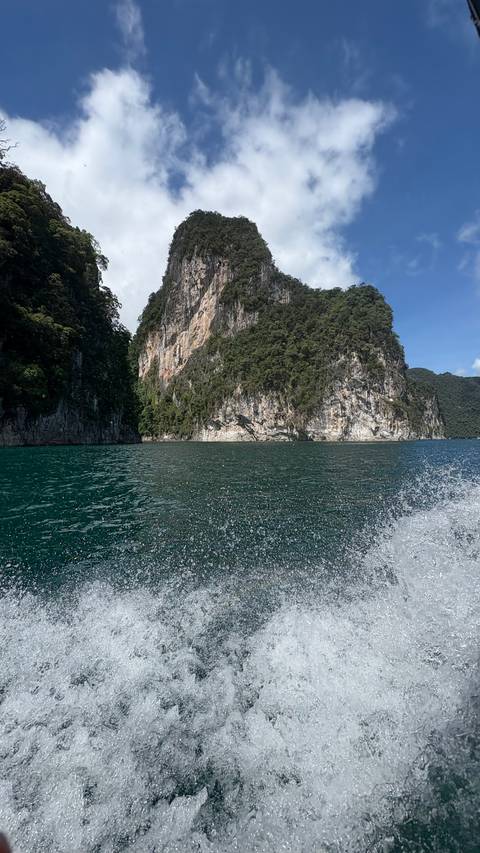 Cliffside view over the ocean with clear water.