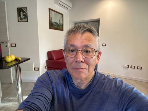 Indoor selfie with a red sofa in the background.