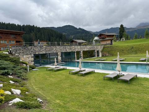 An outdoor swimming pool with mountain views.