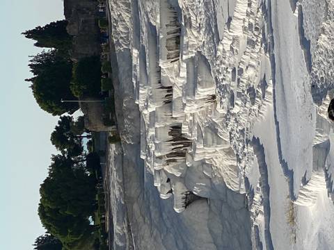       Travertine terraces that look like cascading pools.
  