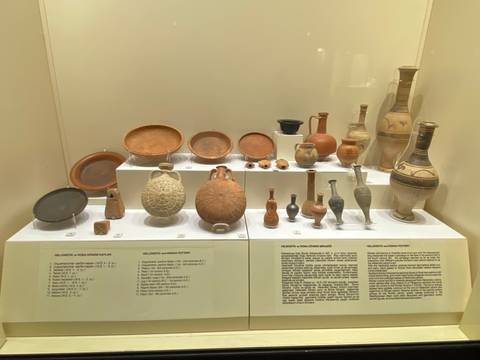       Display of various ancient pottery and artifacts in a museum.
  