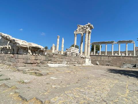       Ancient ruins and columns under a clear blue sky.
  