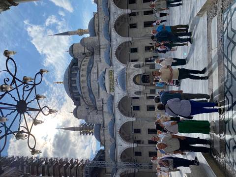 Entrance of the Blue Mosque with people in the foreground.