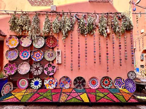 Colorful handcrafted products displayed on a wall.