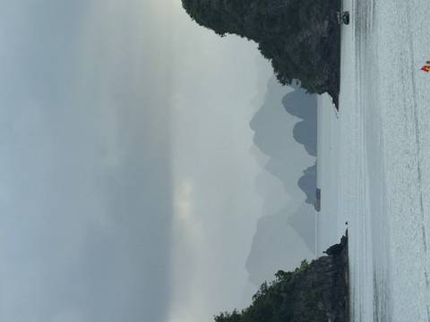       Scenic view of misty limestone islands at dawn.
  