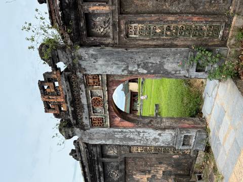       Ancient gate with a view of a courtyard.
  