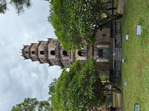       Tall pagoda surrounded by trees.
  