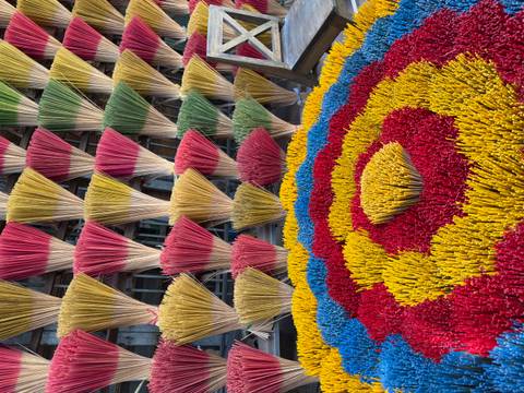       Colorful incense sticks arranged in a pattern.
  