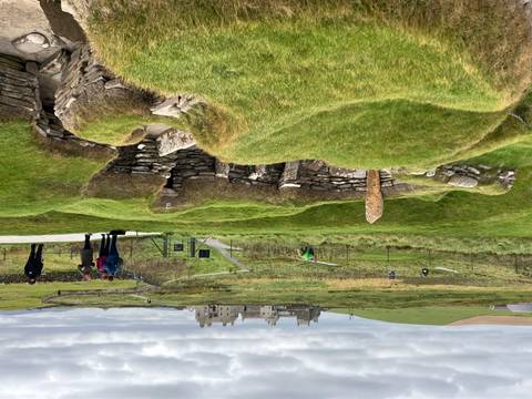 Archaeological site with ancient structures and visitors.