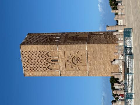       Tall, historical stone tower under a clear blue sky.
  