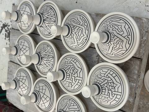       Traditional Moroccan ceramic tagines on display.
  