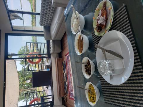 A dining setup on a houseboat with traditional Indian dishes.
