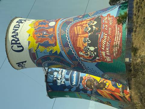       Colorfully painted cooling towers with murals.
  