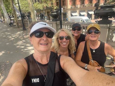 Group selfie of women in a city street.