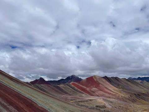       Expansive view of colorful Rainbow Mountain landscape.
  