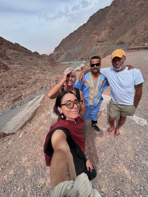       People posing on a rocky terrain.
  