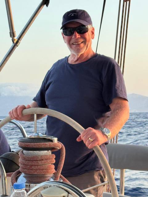 A person steering a boat on the water.