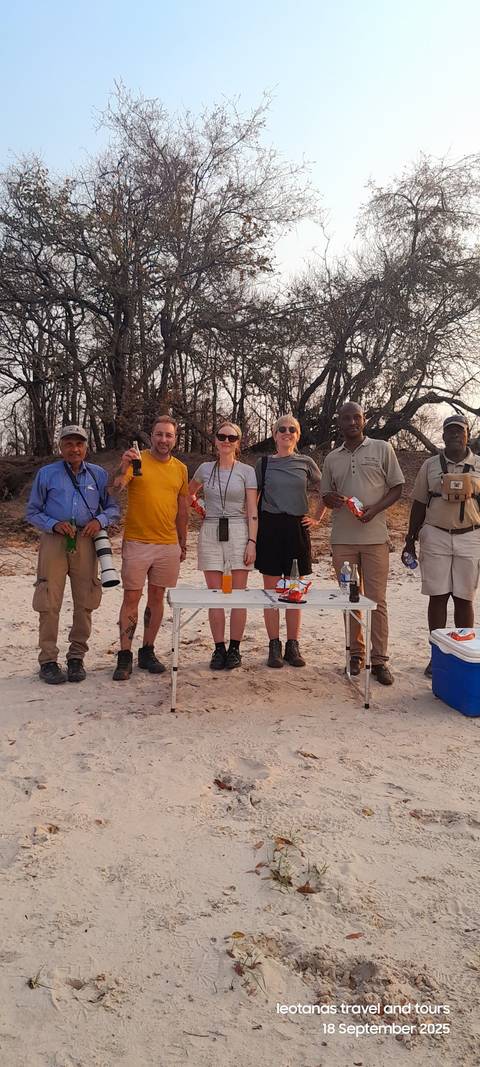 Group of people gathered outdoors with photography equipment.
