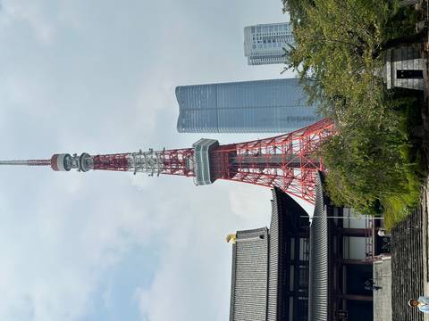 Tokyo Tower with a modern skyscraper in the background.