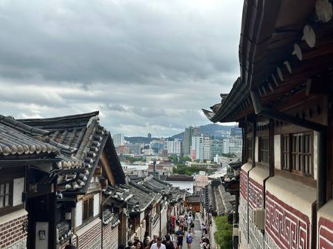 Traditional rooftops overlooking a modern cityscape.