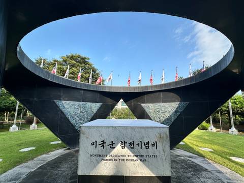 Monument with flags on a clear day.