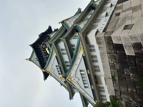 Osaka Castle rising against a cloudy sky.