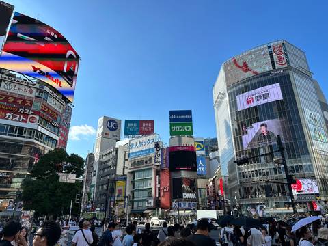 Bustling city center with electronic advertisement boards.