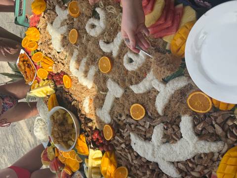 Food spread with fruits and traditional dish decorations.