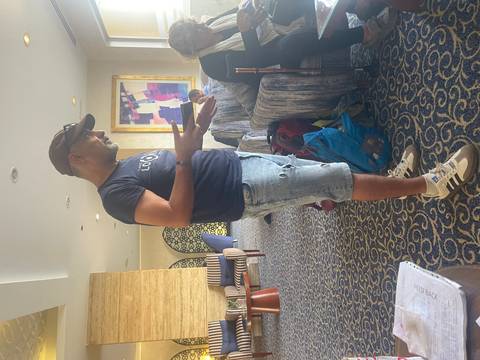 Person interacting with another indoors.