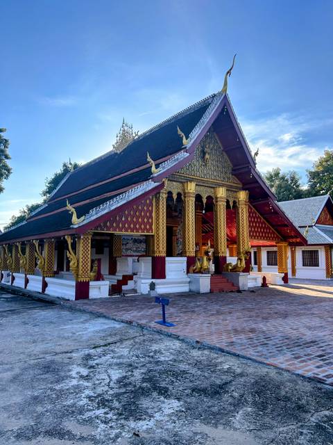 Ornately designed temple with gold detailing and blue skies.