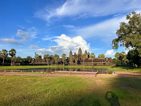 Angkor Wat with clear reflections in water and clear sky.